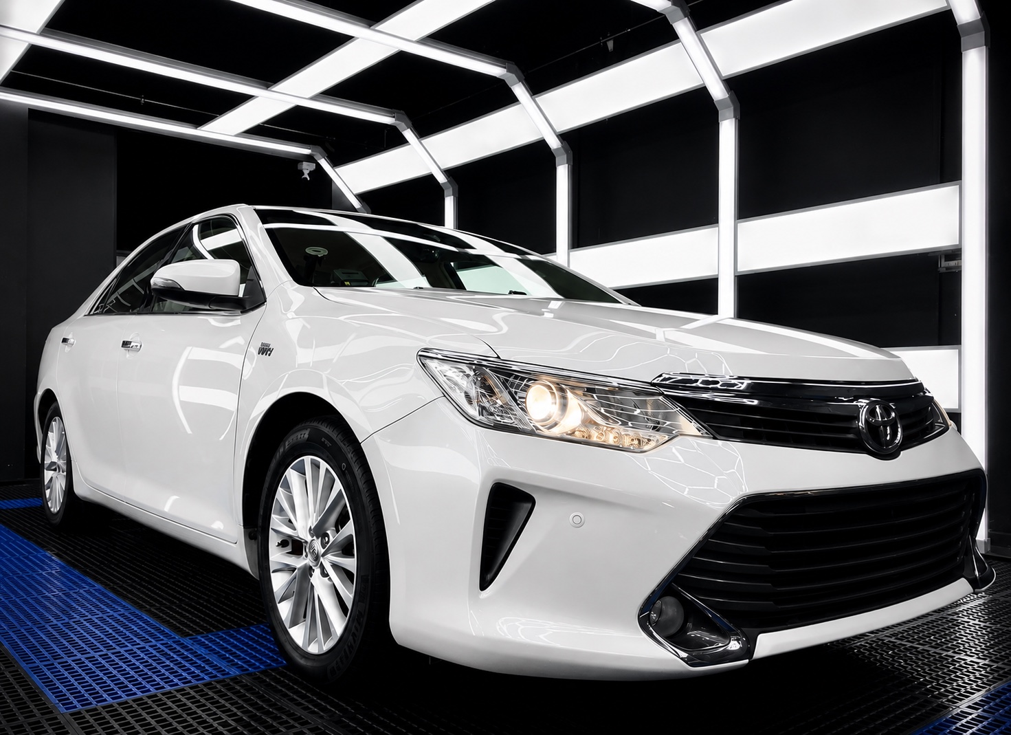 White Toyota sedan under Pure's inspection lighting